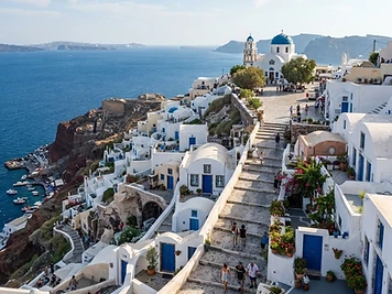 The whitewashed hill village of Serifos, lanes and steps rising to a square and a church above the port.