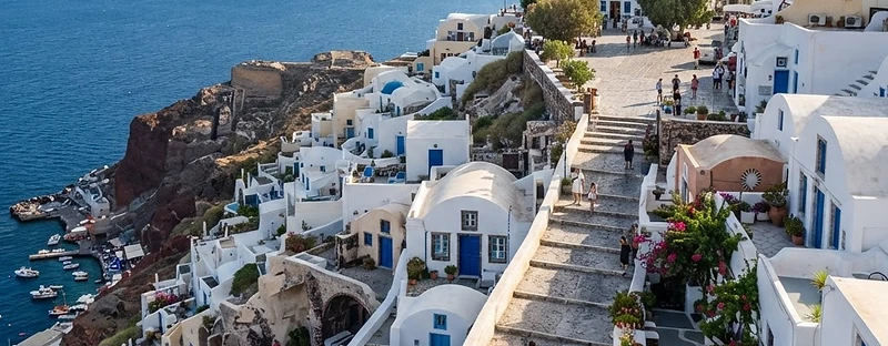 The whitewashed hill village of Serifos, lanes and steps rising to a square and a church above the port.