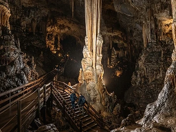 The great central stalactite of the cave of Antiparos, with a walkway and steps descending into the chamber.