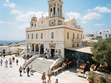The neoclassical facade and marble courtyard of the pilgrimage church of Panagia Evangelistria on Tinos.