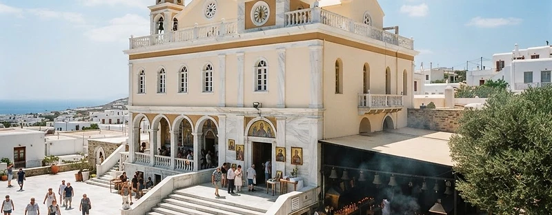 The neoclassical facade and marble courtyard of the pilgrimage church of Panagia Evangelistria on Tinos.