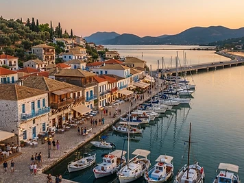 Low houses with wooden upper floors along the waterfront of Lefkada Town, with yachts moored in the marina.