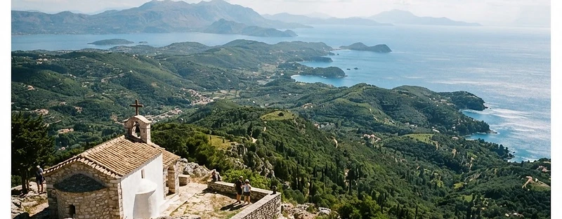 The view from the summit of Mount Pantokrator over wooded hills to the sea.