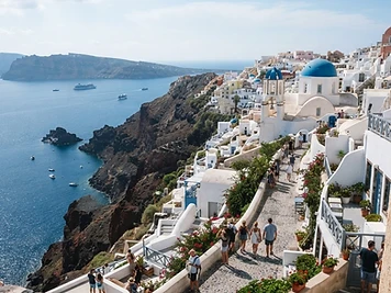 White houses and blue-domed churches on the caldera rim at Imerovigli, Santorini.