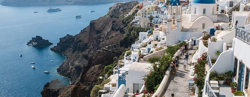 White houses and blue-domed churches on the caldera rim at Imerovigli, Santorini.