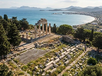 The terraces, steps and fallen columns of the Asklepion of Kos, with a wide bay below and cypresses on the slope.