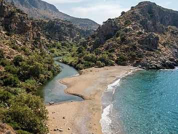 The river mouth at Nas on Ikaria, with sand and tamarisk scrub meeting the sea between two headlands.