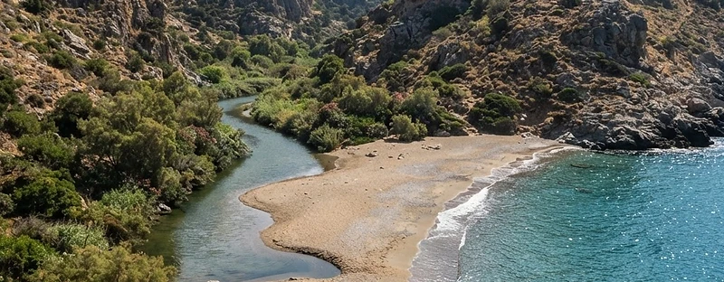 The river mouth at Nas on Ikaria, with sand and tamarisk scrub meeting the sea between two headlands.