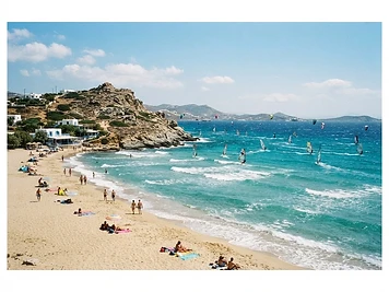 The wide sandy beach and turquoise water at Mikri Vigla on Naxos, with windsurfers offshore.