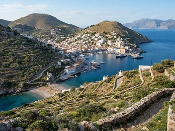The twin hills and harbour of Ermoupoli on Syros seen from the surrounding hillside.