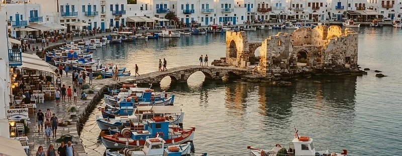 Fishing boats and whitewashed houses around the small harbour of Naoussa, Paros.