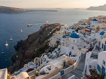 Santorini caldera village with blue domes above the Aegean
