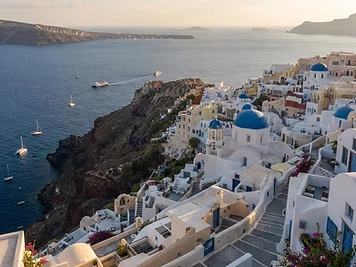 Santorini caldera village with blue domes above the Aegean