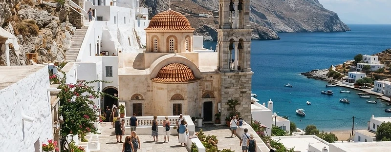 The whitewashed courtyard and red-domed church of the monastery at Panormitis on the south coast of Symi.