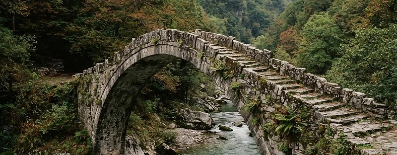 An old stone packhorse bridge over a mountain river in Zagori