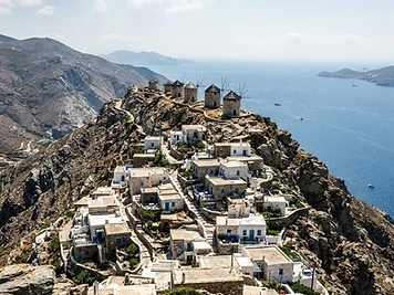 The remote village of Olympos on Karpathos strung along a ridge, with flat-roofed houses and windmills on the crest.