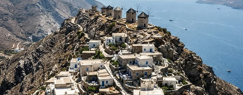 The remote village of Olympos on Karpathos strung along a ridge, with flat-roofed houses and windmills on the crest.
