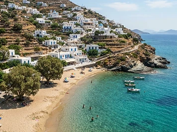 The small sheltered sandy cove at Livada below the hillside village on Tinos.