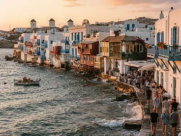 Colourful balconied houses built directly over the water at Little Venice, Mykonos.
