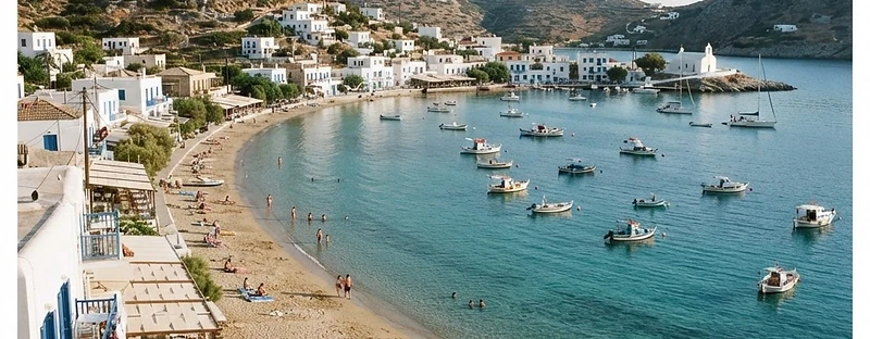 The sheltered inlet and sandy beach at Vathi on Sifnos, ringed by white houses.