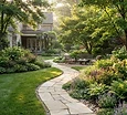 A lush manicured backyard with a stone path