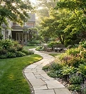 A lush manicured backyard with a stone path