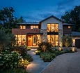 A welcoming modern home exterior with warm lights on