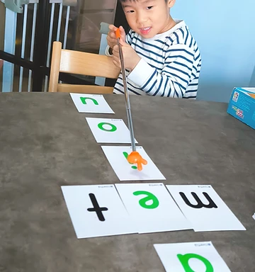 Child learning letters with phonics cards