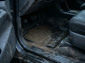 Water intrusion under the floor carpet after flooding — before