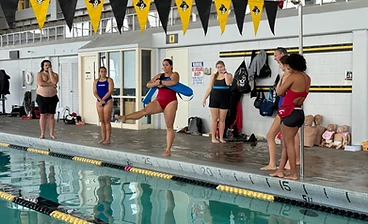 Lifeguard training class standing on the pool deck
