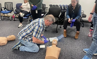 Classroom AED and CPR manikin practice session