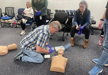 Classroom AED and CPR manikin practice session