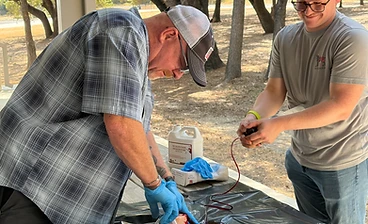 Stop the Bleed wound packing practice at an outdoor pavilion training session