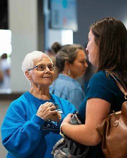 A hospitality volunteer greeting a guest