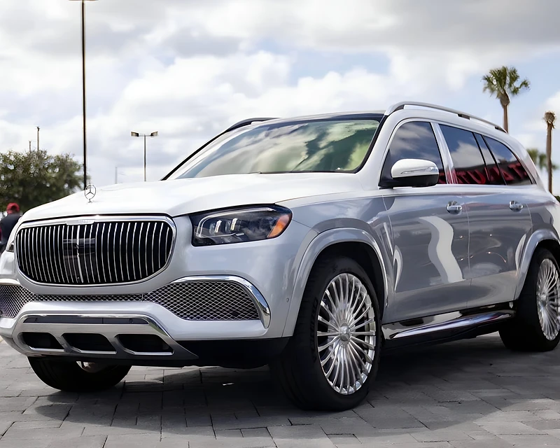 Black Mercedes-Maybach luxury SUV parked at a modern Orlando estate at night