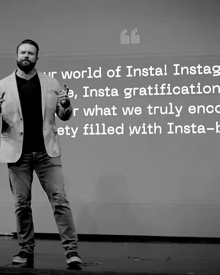 James Woodford speaking on stage
