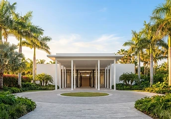 Modern white arrival pavilion with a formal entrance court