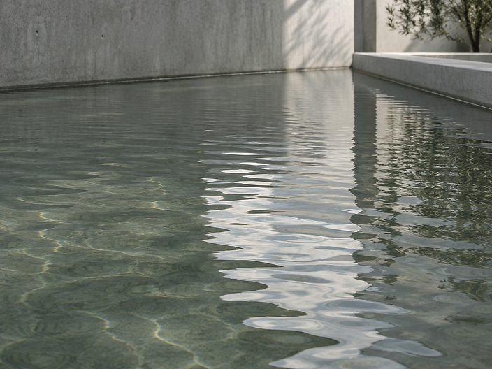 Calm rippling water surface in a concrete basin
