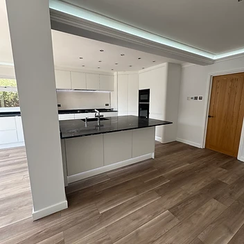 Modern kitchen island with integrated lighting and cabinetry, UC-Homes.