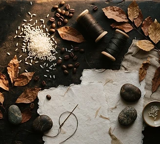 Natural art materials arranged on a dark surface