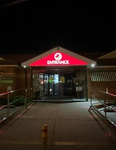 Illuminated entrance sign at night