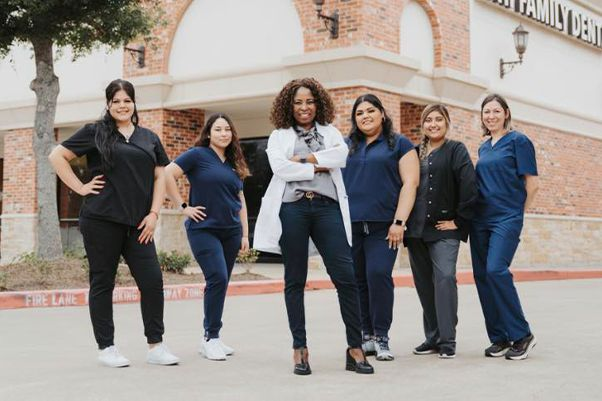 Chi Family Dental team posing outside the office