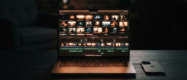 Founder's laptop showing a product launch video timeline with cinematic AI-generated clips
