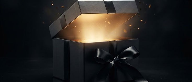 A gift box tied with a black ribbon opening under dramatic spotlight to reveal a glowing product