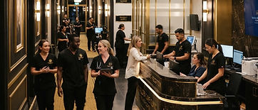 Busy private hospital interior with gold and black accents, staff in black scrubs