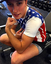 Lacie flexing in the gym wearing an American flag shirt