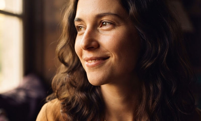 A person looking toward soft window light