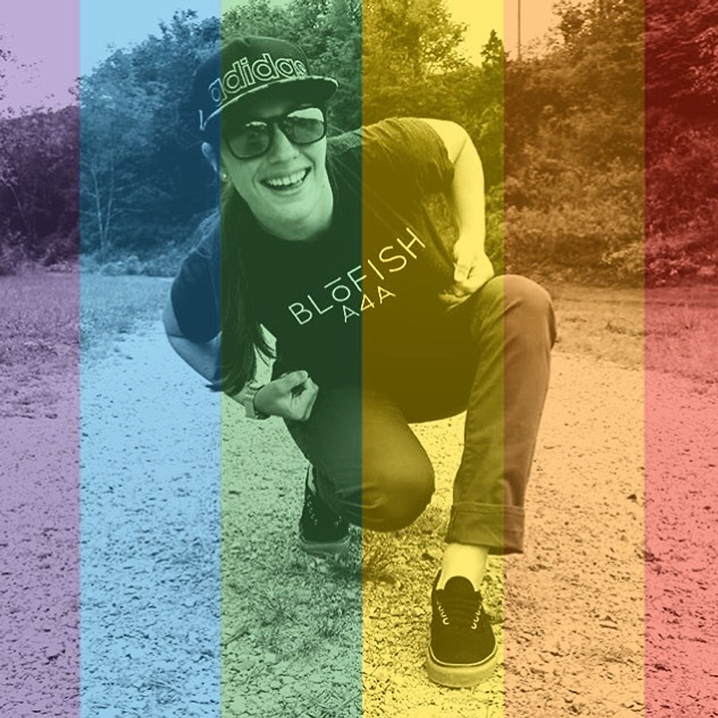 Lacie crouching on a gravel path under a rainbow-stripe filter