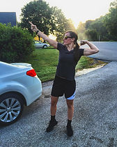 Lacie flexing at sunset in a driveway