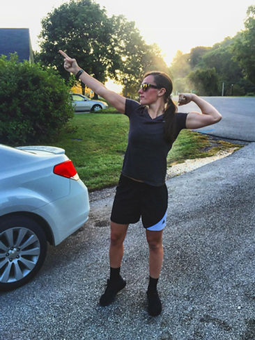 Lacie flexing at sunset in a driveway